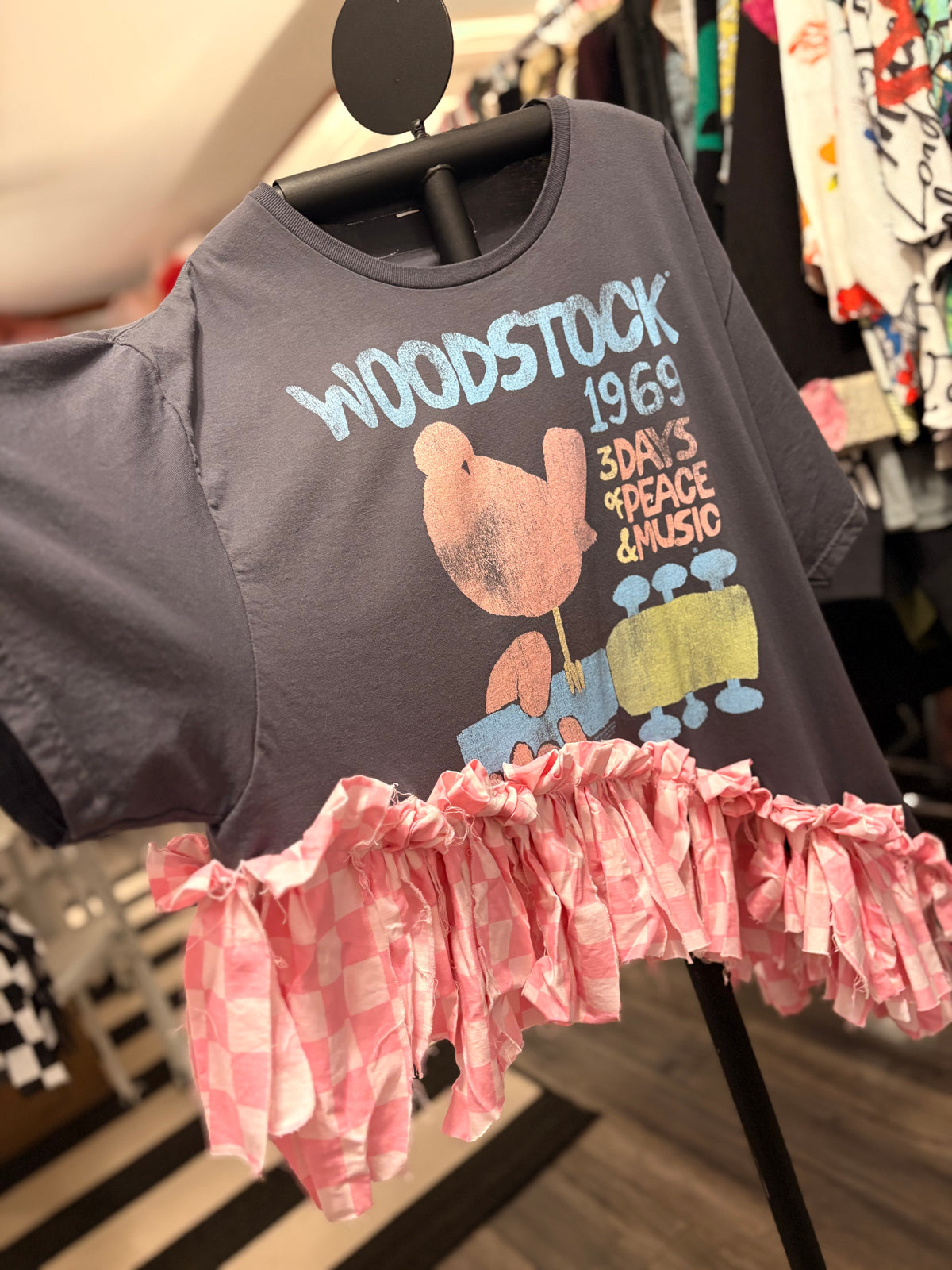 Woodstock Checker Fringe Asymmetrical Tee One Size Fits Small to 3X