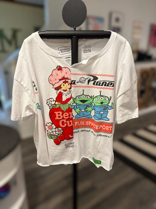Vintage-inspired white tee featuring Strawberry Shortcake and Toy Story aliens, perfect for casual wear. Front